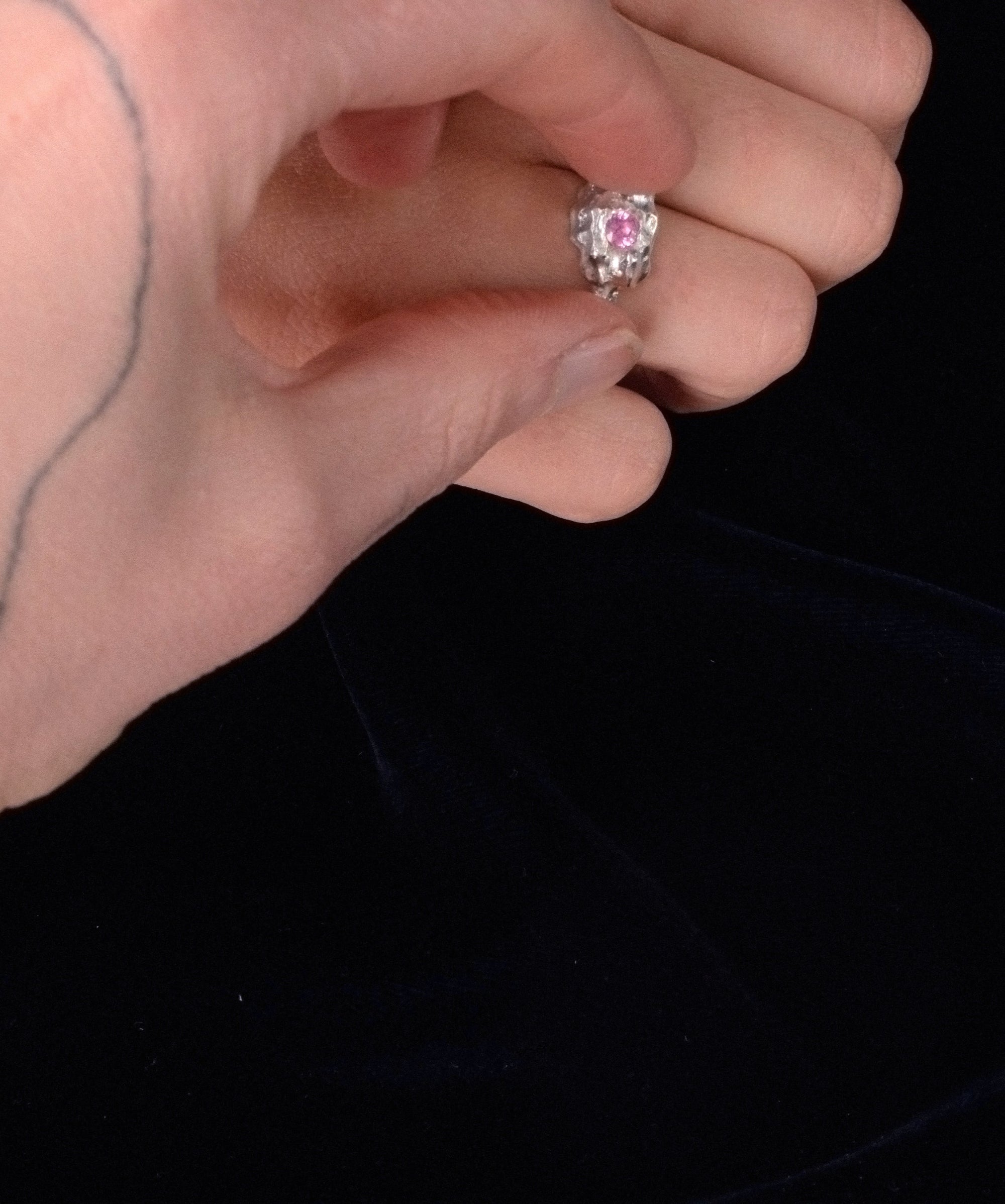 Molten silver gemstone ring – raw textured band with pink sapphire detail